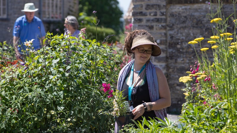 Staff member in the plant sales area at Lytes Cary Manor, Somerset